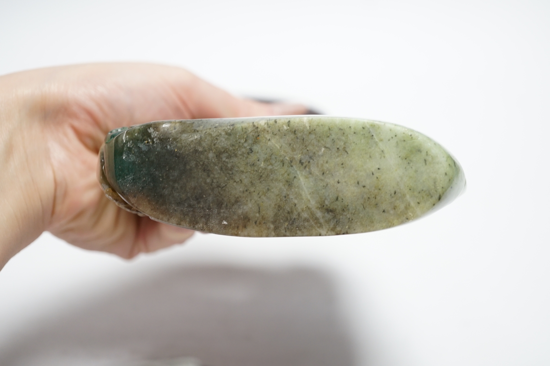A Chinese jadeite boulder carving on hardwood stand, 17cm high
